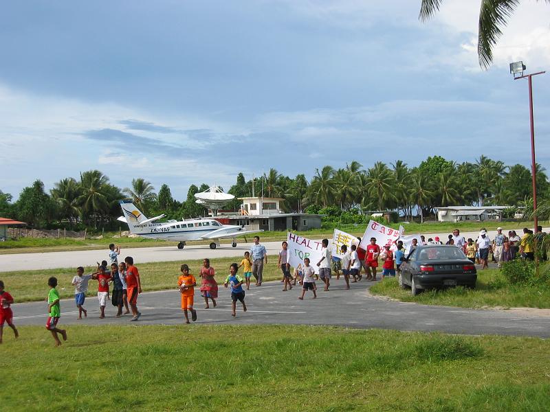 tuv27 On this day, two exciting events took place simultaneously at the Funafuti Airport. A private plane is about to take off, and a crowd of demonstrators has gathered to show their support for Taiwan.